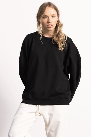 Blonde female model wearing a Black heavyweight sweatshirt