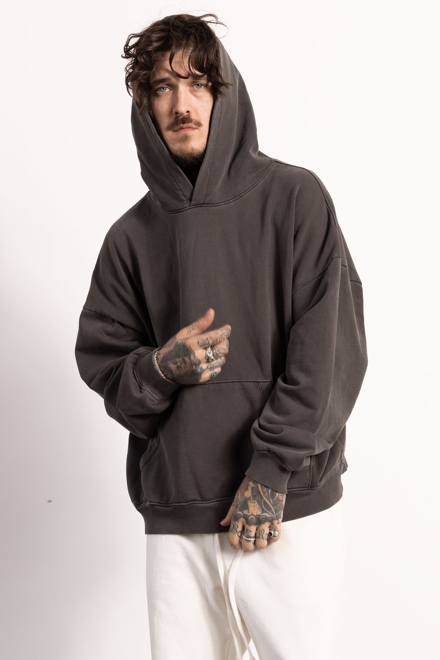 White male model with tattoos wearing a Drop Shoulder Pima Cotton Hoodie