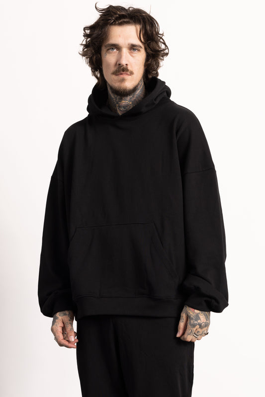 White male model with edgy style and tattoos wearing a Drop Shoulder Pima Cotton Hoodie