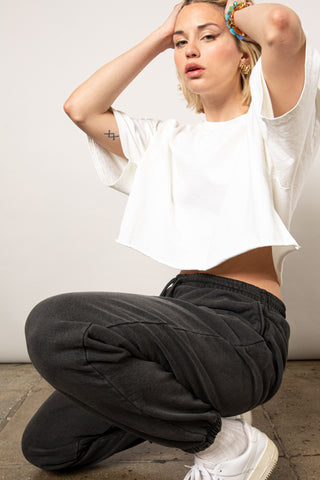white female edgy model wearing black sweatpants